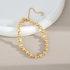 Gold-color round bead bracelet with brushed beads and extender chain