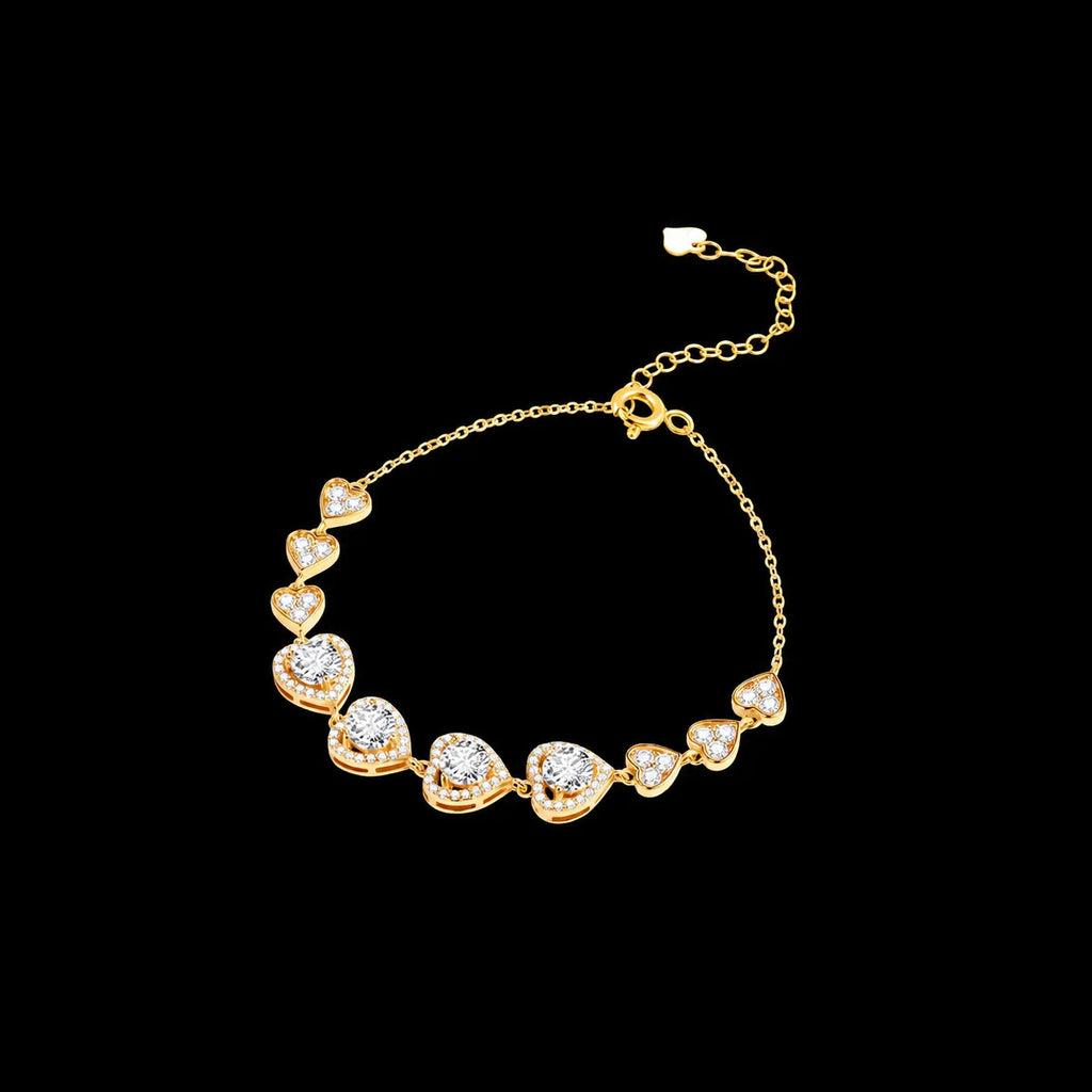 Gold-tone ten-heart bracelet with a spring ring clasp and extender chain on a black background
