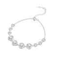 Silver heart link bracelet on white, with four larger center hearts and three smaller hearts on each side