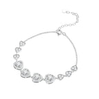 Silver heart link bracelet on white, with four larger center hearts and three smaller hearts on each side