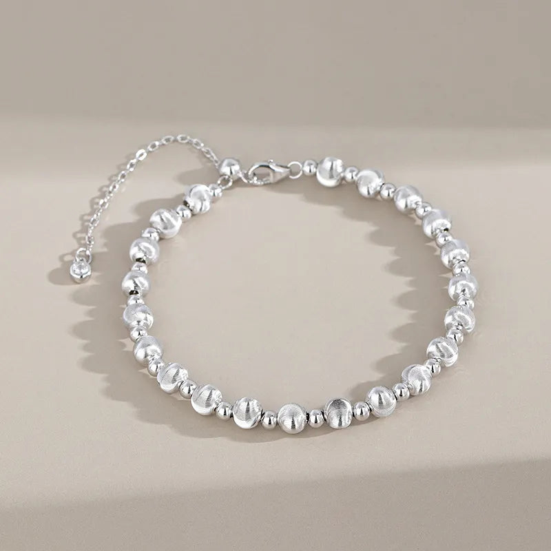 Silver round bead bracelet with brushed beads and polished spacers